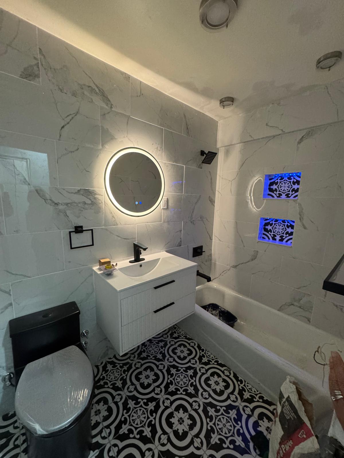 Complete bathroom view with lighting