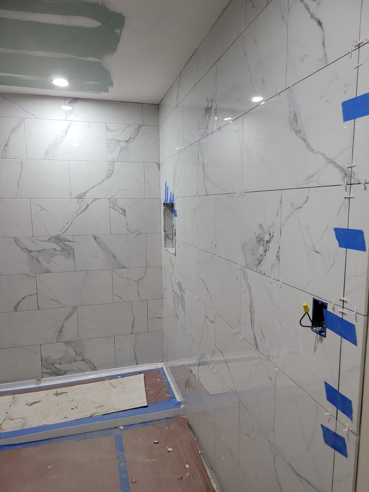 Bathroom tile installation in progress